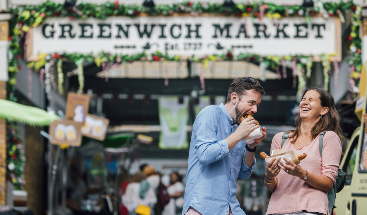 A couple eating food at Greenwich Market Food Court.